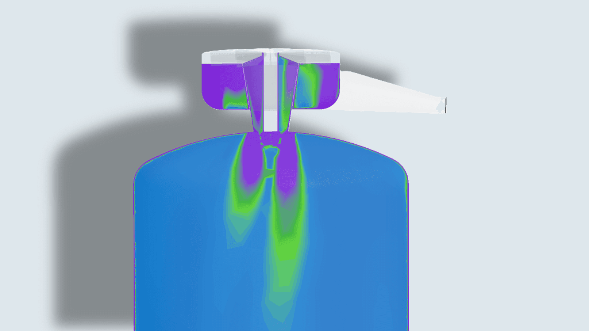 CFD cross-section of a spray dryer chamber showing atomizer inlet and drying gas flow, with a color gradient from purple to green to blue illustrating the distribution of temperature, velocity, or humidity from the nozzle into the drying chamber.